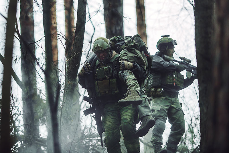 soldiers evacuating a war zone